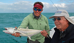 Former President Jimmy Carter, right, displays a Spanish mackerel he caught Thursday while fishing off Marathon with Captain Rich Tudor (left). Photo by Derek Rust/Florida Keys News Bureau